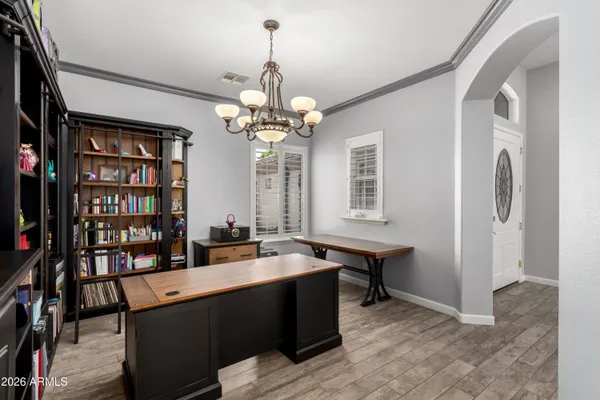 a view of a patio with table and chairs potted plants with wooden floor and fence