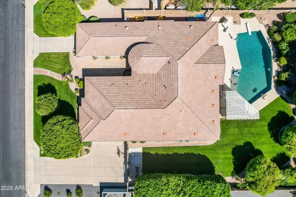 a front view of a house with a yard and potted plants