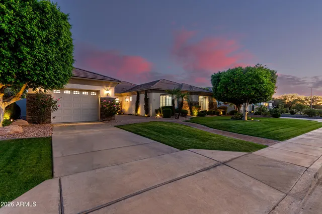 a view of a hallway with wooden floor and a living room