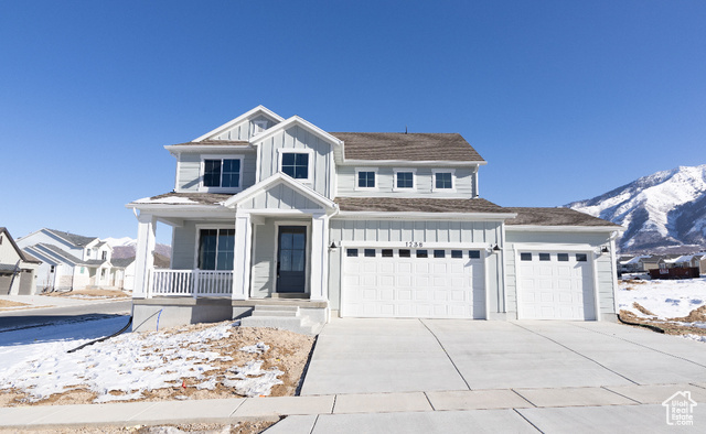 1238 North Prairie Dog Terrace, Unit 20 Elk Ridge, UT 84651 - Photo 1 of 1 View of front facade featuring a mountain view, a garage, and covered porch