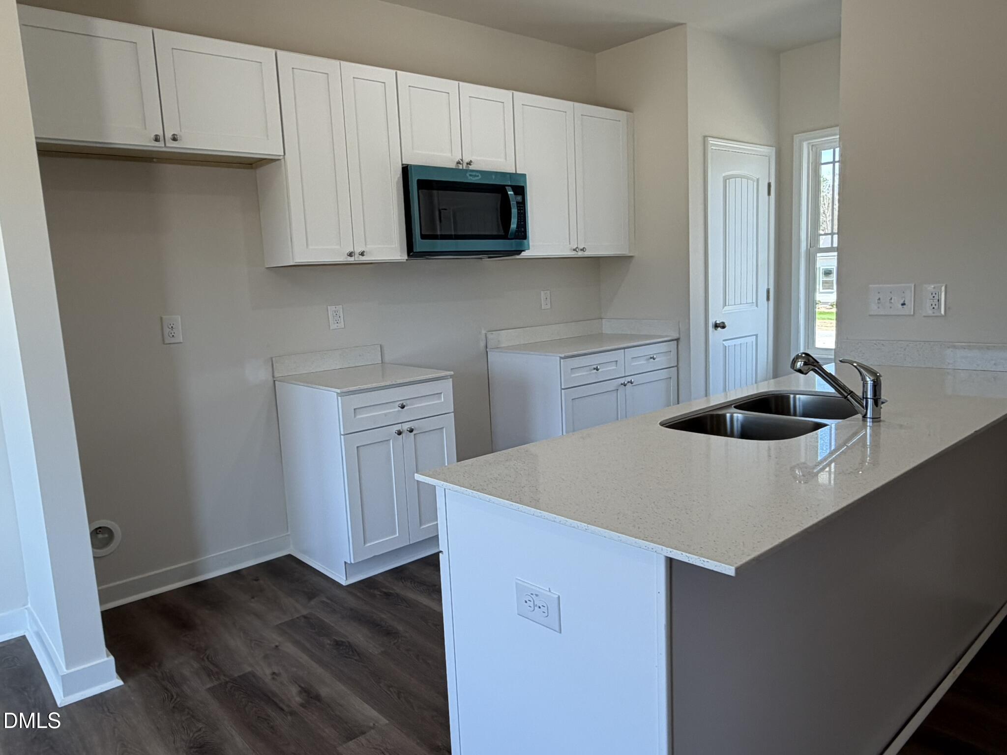 159 Jacobs Ridge Drive Four Oaks, NC 27524 - Photo 5 of 19 a kitchen with a sink a microwave and cabinets