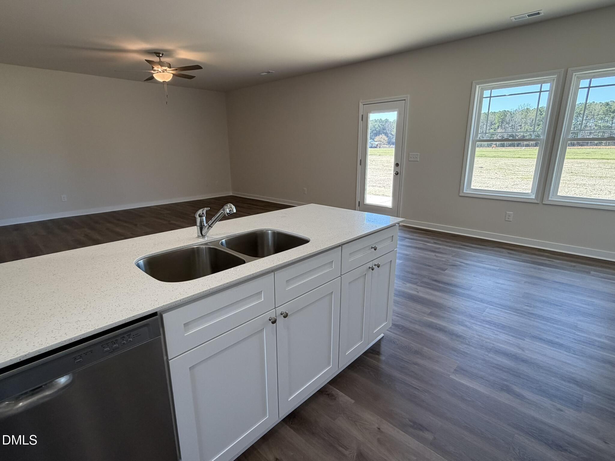 159 Jacobs Ridge Drive Four Oaks, NC 27524 - Photo 7 of 19 a kitchen with a sink cabinets and wooden floor