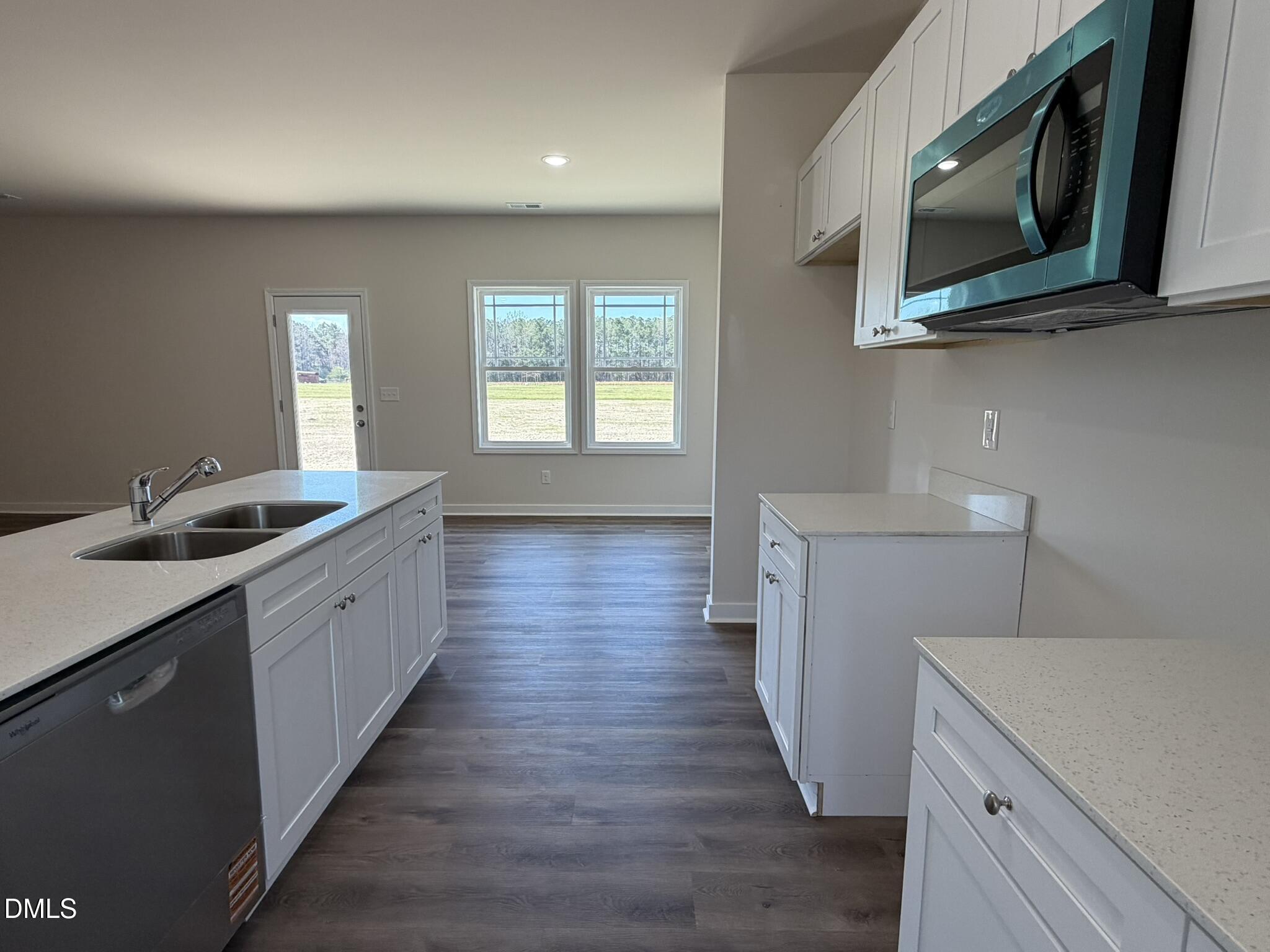 159 Jacobs Ridge Drive Four Oaks, NC 27524 - Photo 8 of 19 a kitchen with sink cabinets and wooden floor