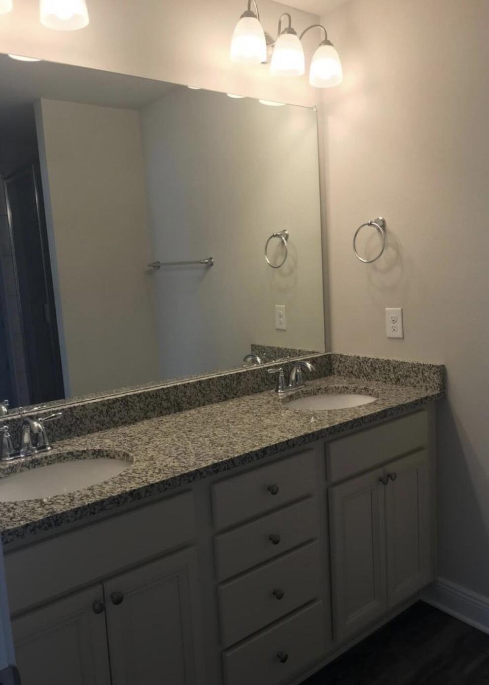 89 Crossing Lane, Unit A Santa Rosa Beach, FL 32459 - Photo 11 of 17 a bathroom with a granite countertop sink and a mirror