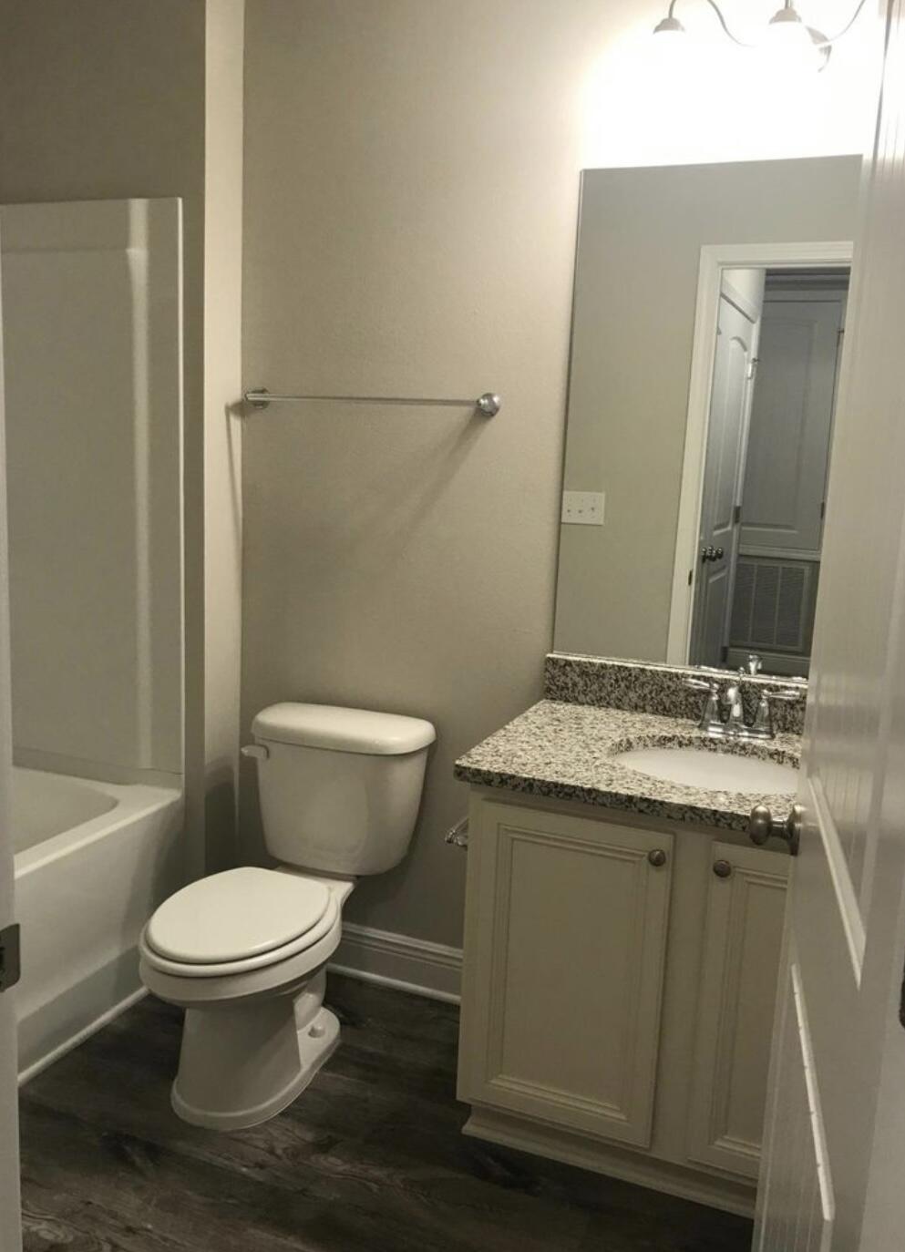 89 Crossing Lane, Unit A Santa Rosa Beach, FL 32459 - Photo 15 of 17 a bathroom with a granite countertop toilet a sink and a mirror