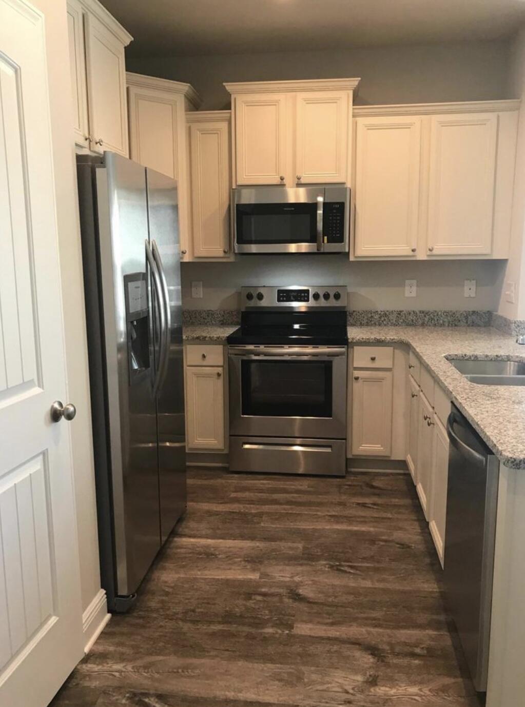 89 Crossing Lane, Unit A Santa Rosa Beach, FL 32459 - Photo 7 of 17 a kitchen with stainless steel appliances granite countertop a stove a refrigerator and a microwave