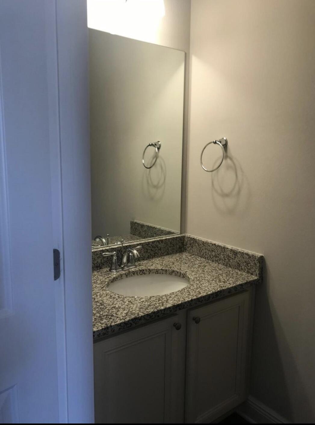 89 Crossing Lane, Unit A Santa Rosa Beach, FL 32459 - Photo 8 of 17 a bathroom with a granite countertop sink and mirror