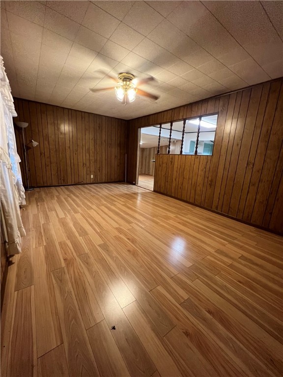604 Southwest 9th Street Premont, TX 78375 - Photo 4 of 16 an empty room with wooden floor and windows