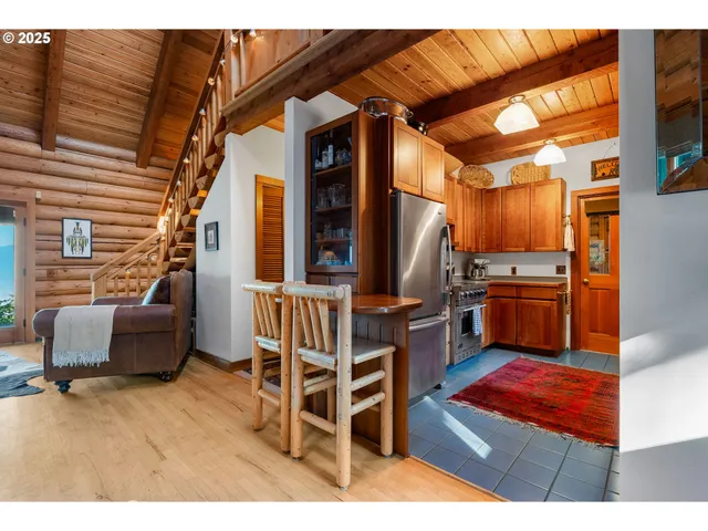 a backyard of a house with barbeque oven table and chairs