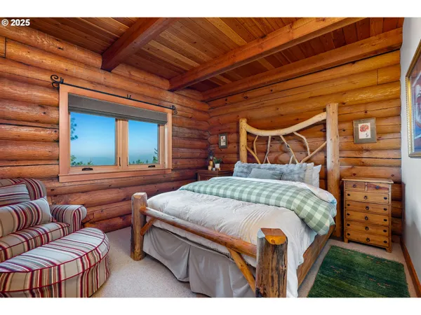 a bedroom with furniture and a large mirror