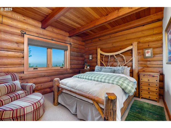 a bedroom with furniture and a large window