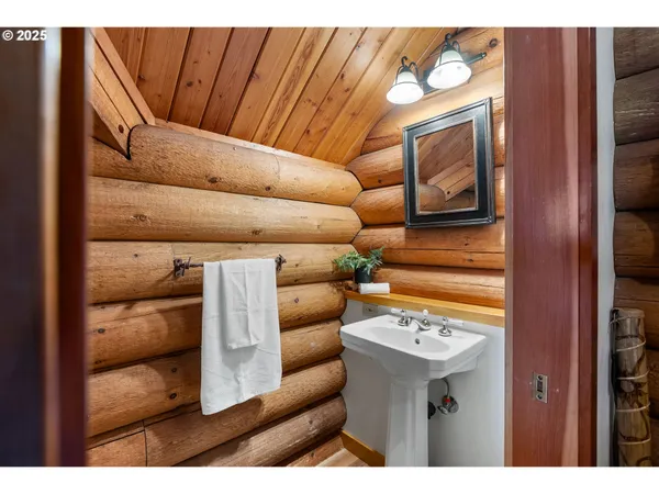 a living room with furniture a window and wooden floor