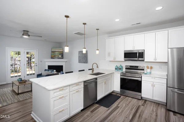 a kitchen with a sink stove and refrigerator