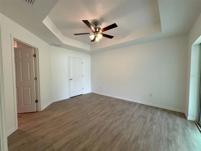 a view of empty room with wooden floor