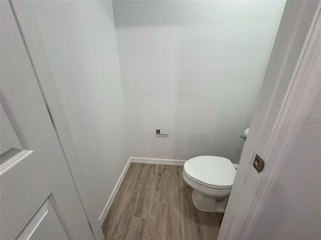 a white toilet sitting next to a sink