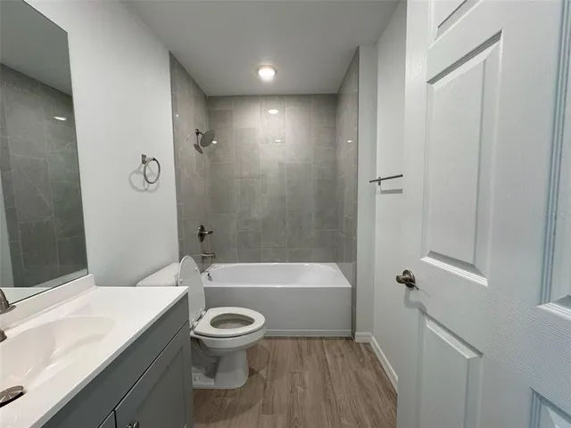 a bathroom with a toilet a sink and bathtub