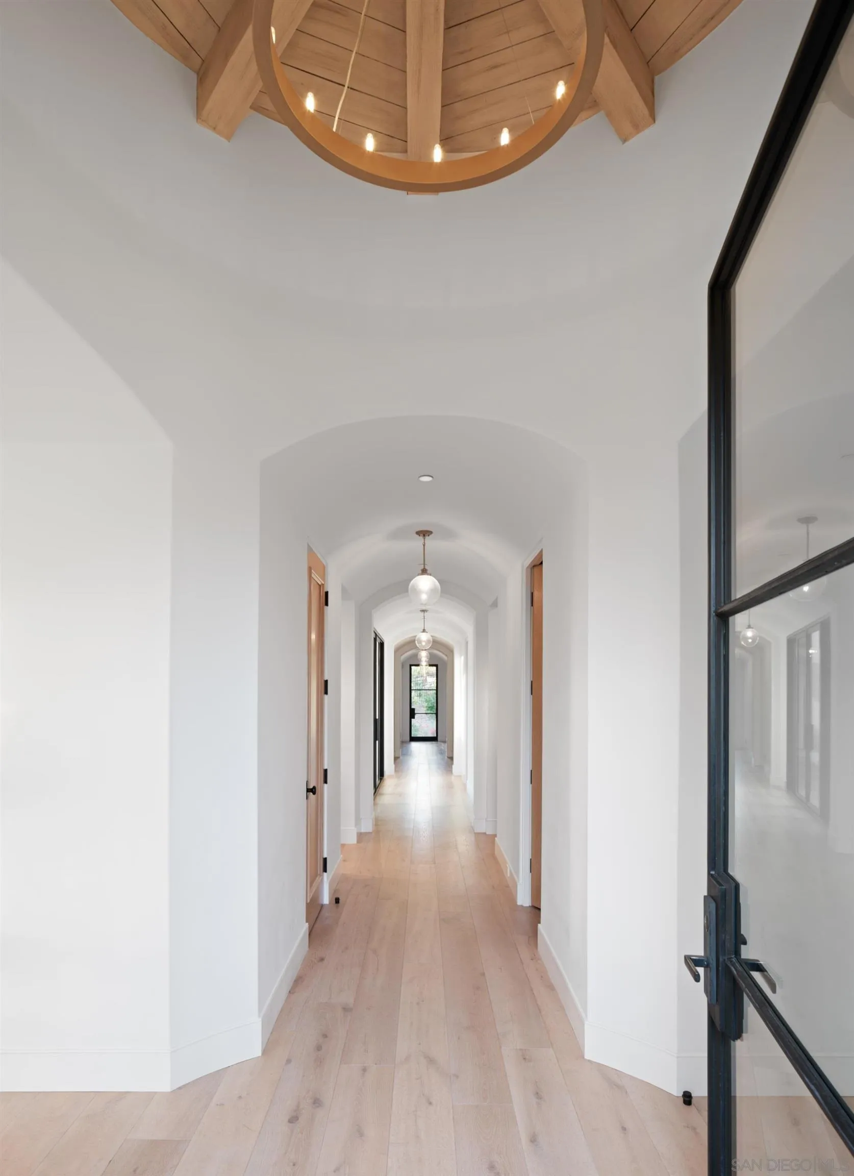 574 Amphitheatre Drive Del Mar, CA 92014 - Photo 22 of 37 a view of a hallway with wooden floor and staircase