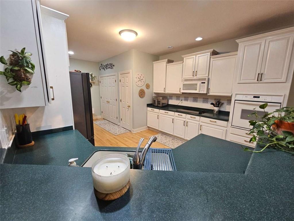 200 Chaparral Trace Tyrone, GA 30290 - Photo 12 of 52 a living room with furniture and a flat screen tv