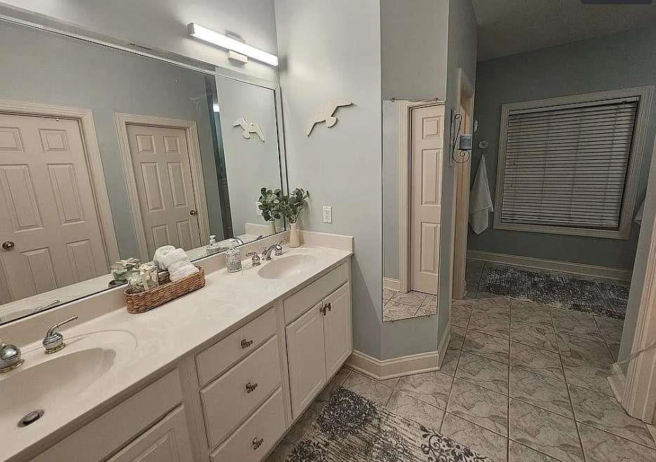 200 Chaparral Trace Tyrone, GA 30290 - Photo 23 of 52 a bathroom with a double vanity sink and mirror