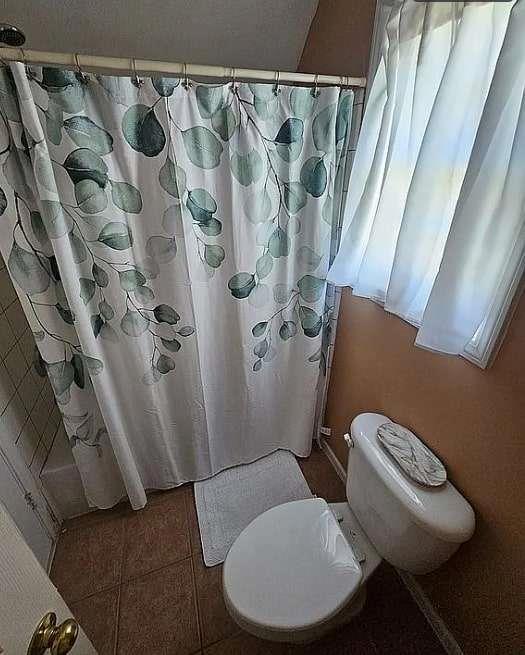 200 Chaparral Trace Tyrone, GA 30290 - Photo 41 of 52 a bathroom with a toilet and a shower curtain