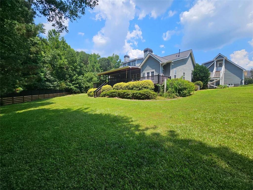 200 Chaparral Trace Tyrone, GA 30290 - Photo 49 of 52 a view of a house with a big yard potted plants and a large tree