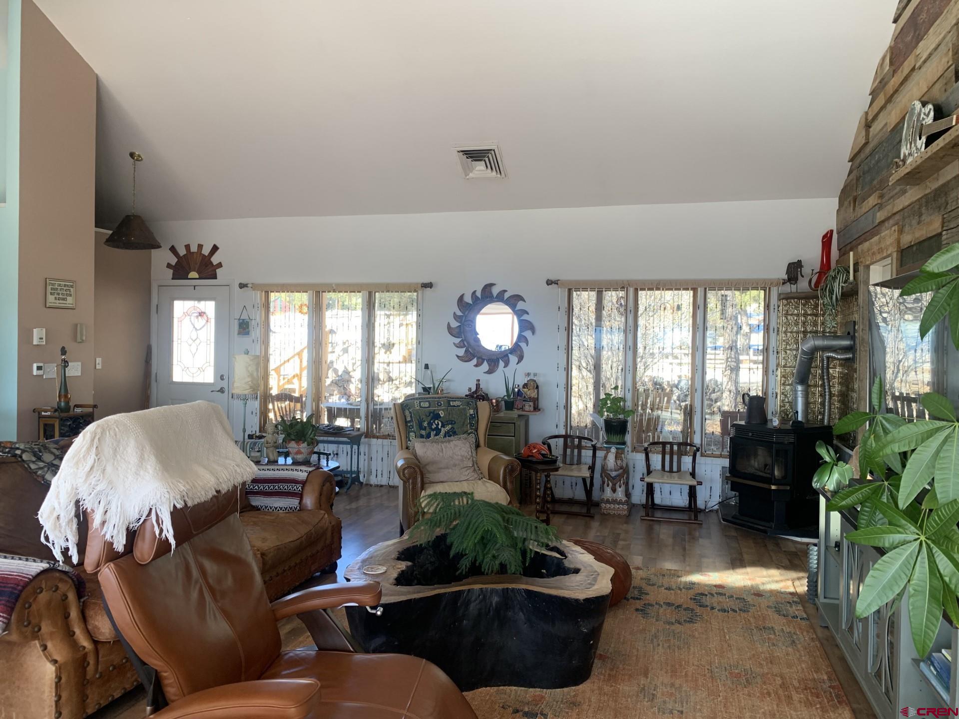 17679 2550 Road Cedaredge, CO 81413 - Photo 13 of 35 a living room with furniture and a large window