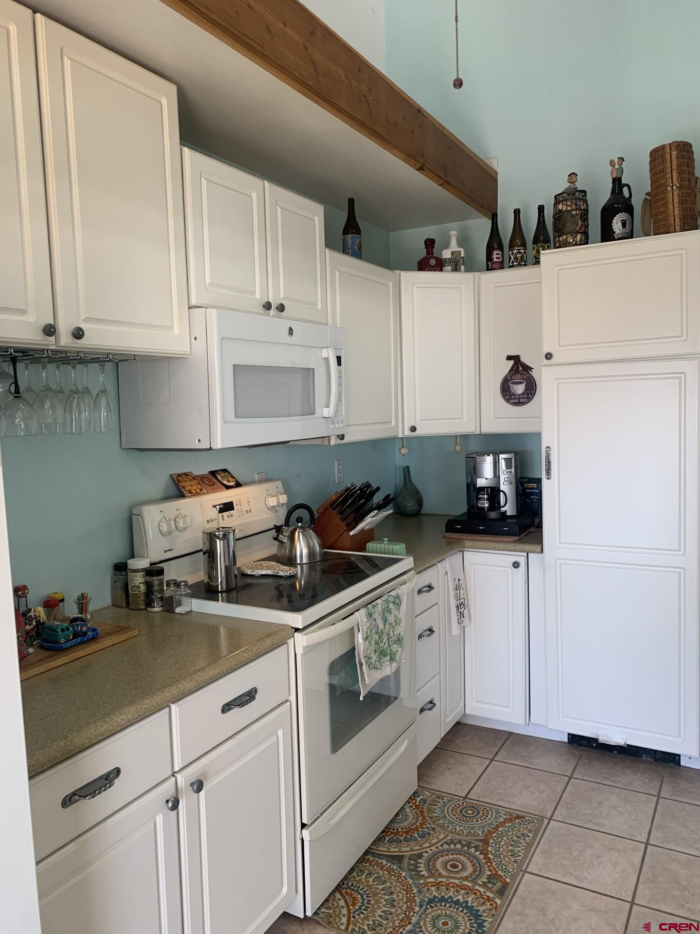 17679 2550 Road Cedaredge, CO 81413 - Photo 16 of 35 a kitchen with white cabinets and white appliances