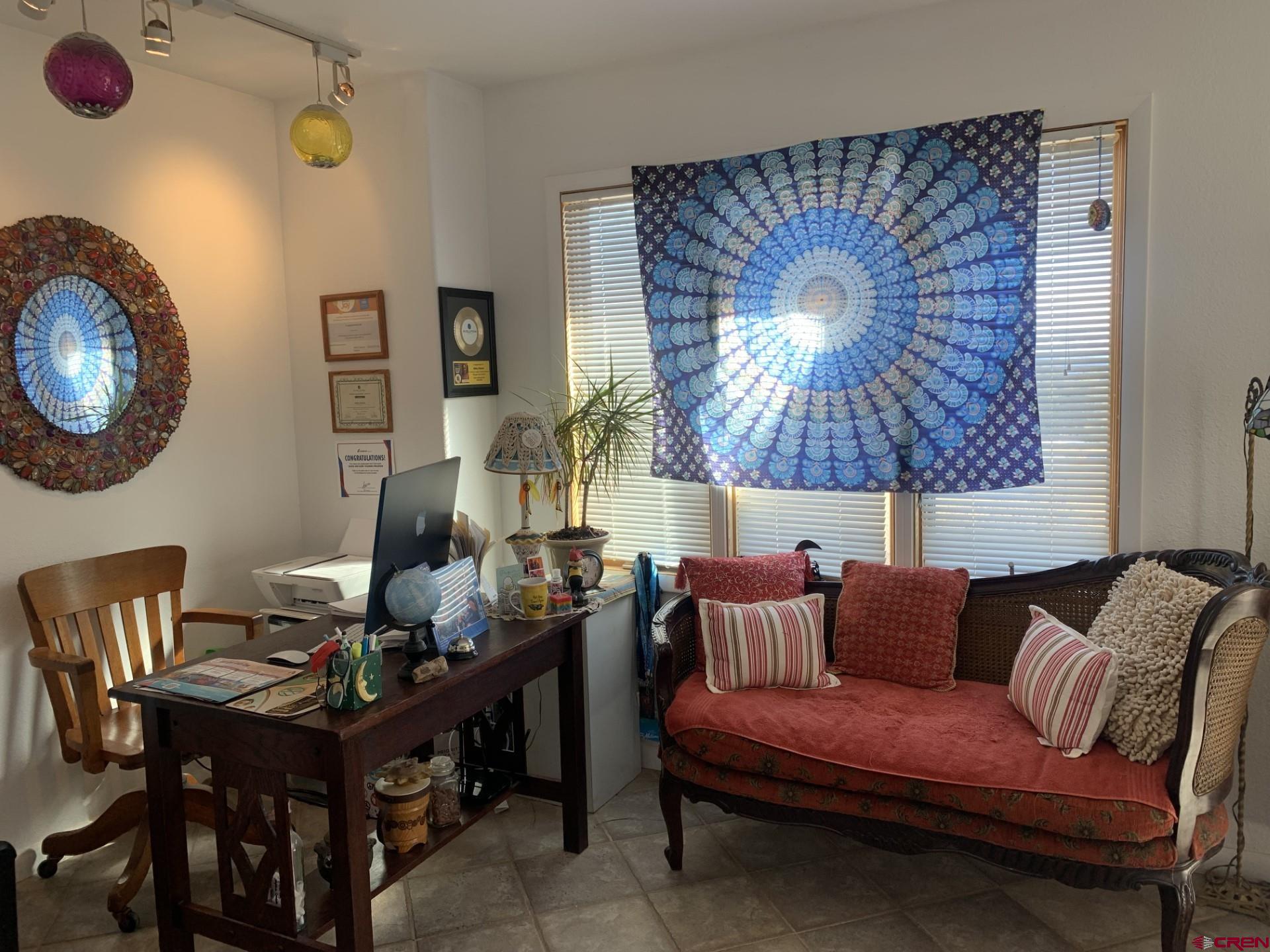17679 2550 Road Cedaredge, CO 81413 - Photo 20 of 35 a living room with furniture and a lamp