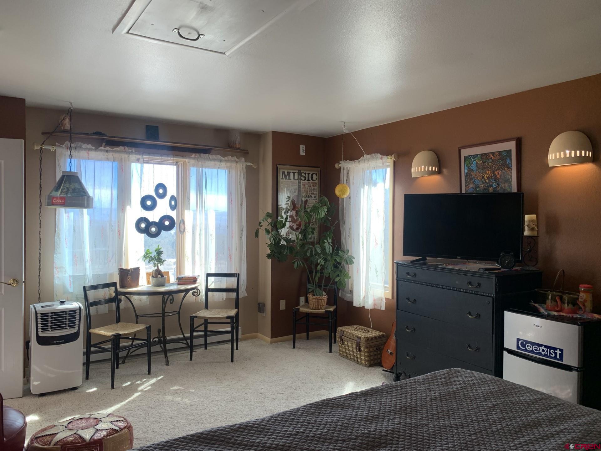 17679 2550 Road Cedaredge, CO 81413 - Photo 28 of 35 a living room with furniture and a flat screen tv