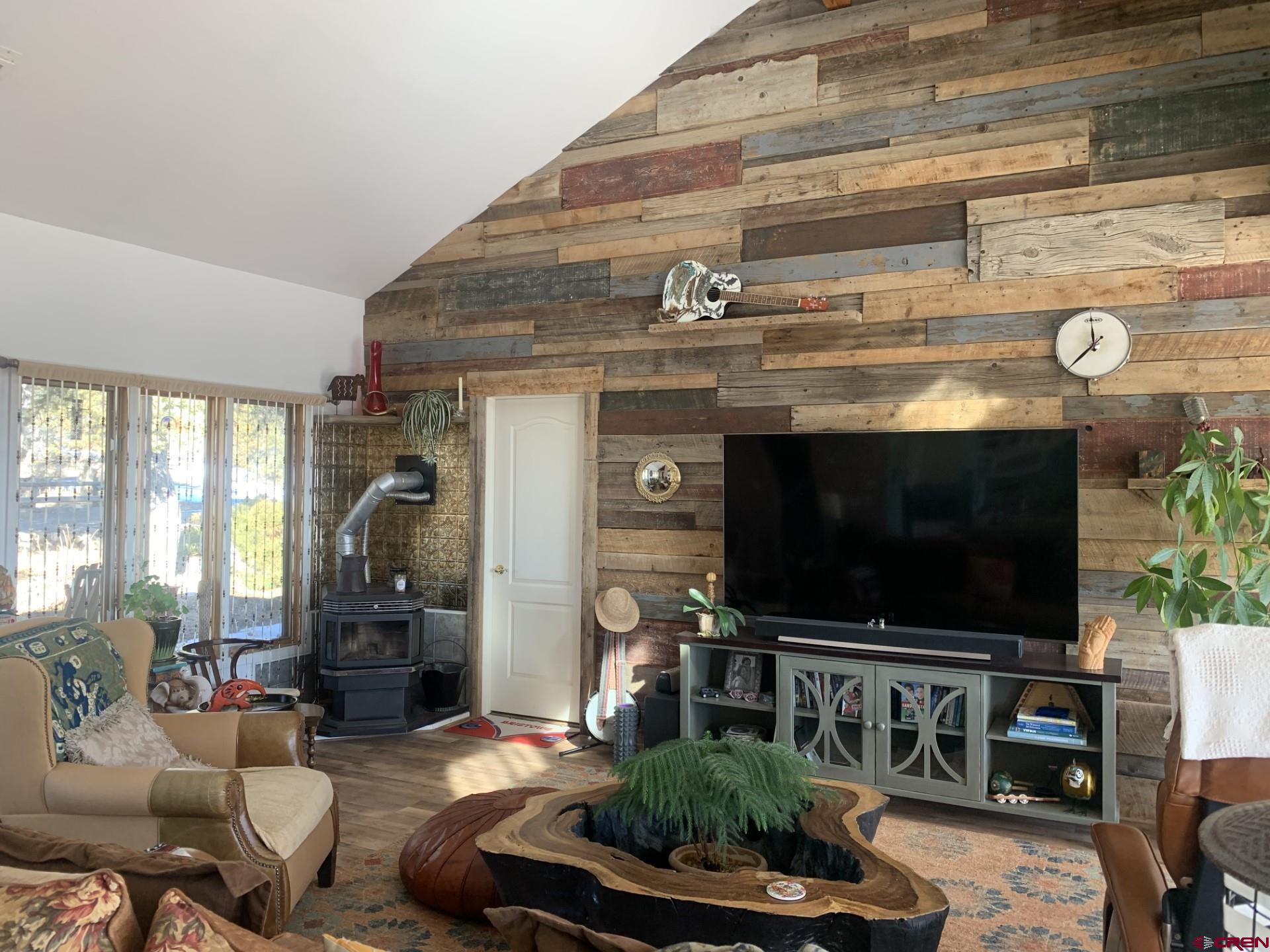 17679 2550 Road Cedaredge, CO 81413 - Photo 10 of 35 a living room with furniture and a flat screen tv