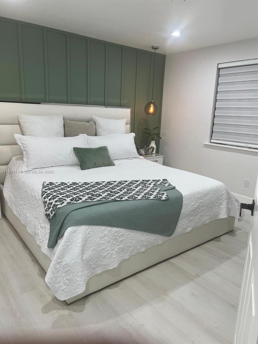 26831 Southwest 119th Court Homestead, FL 33032 - Photo 14 of 27 a bedroom with a large bed and a couch
