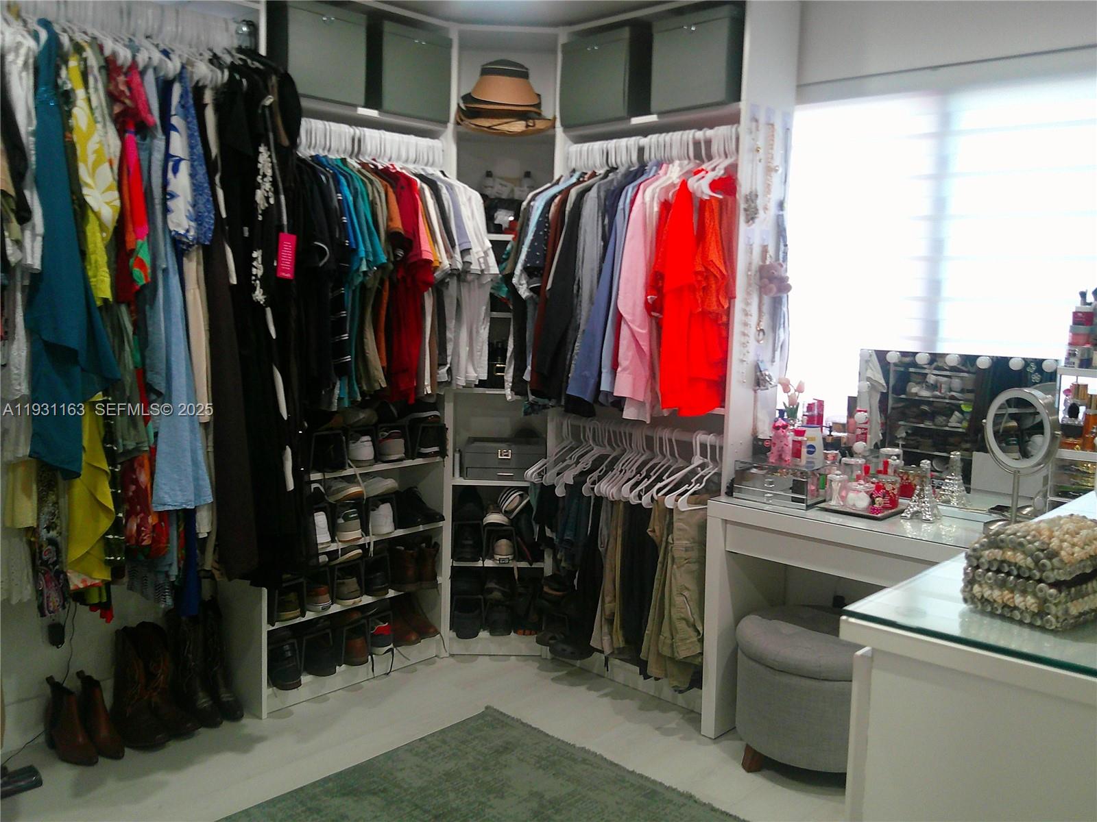 26831 Southwest 119th Court Homestead, FL 33032 - Photo 15 of 27 a view of walk in closet with clothes and shoes