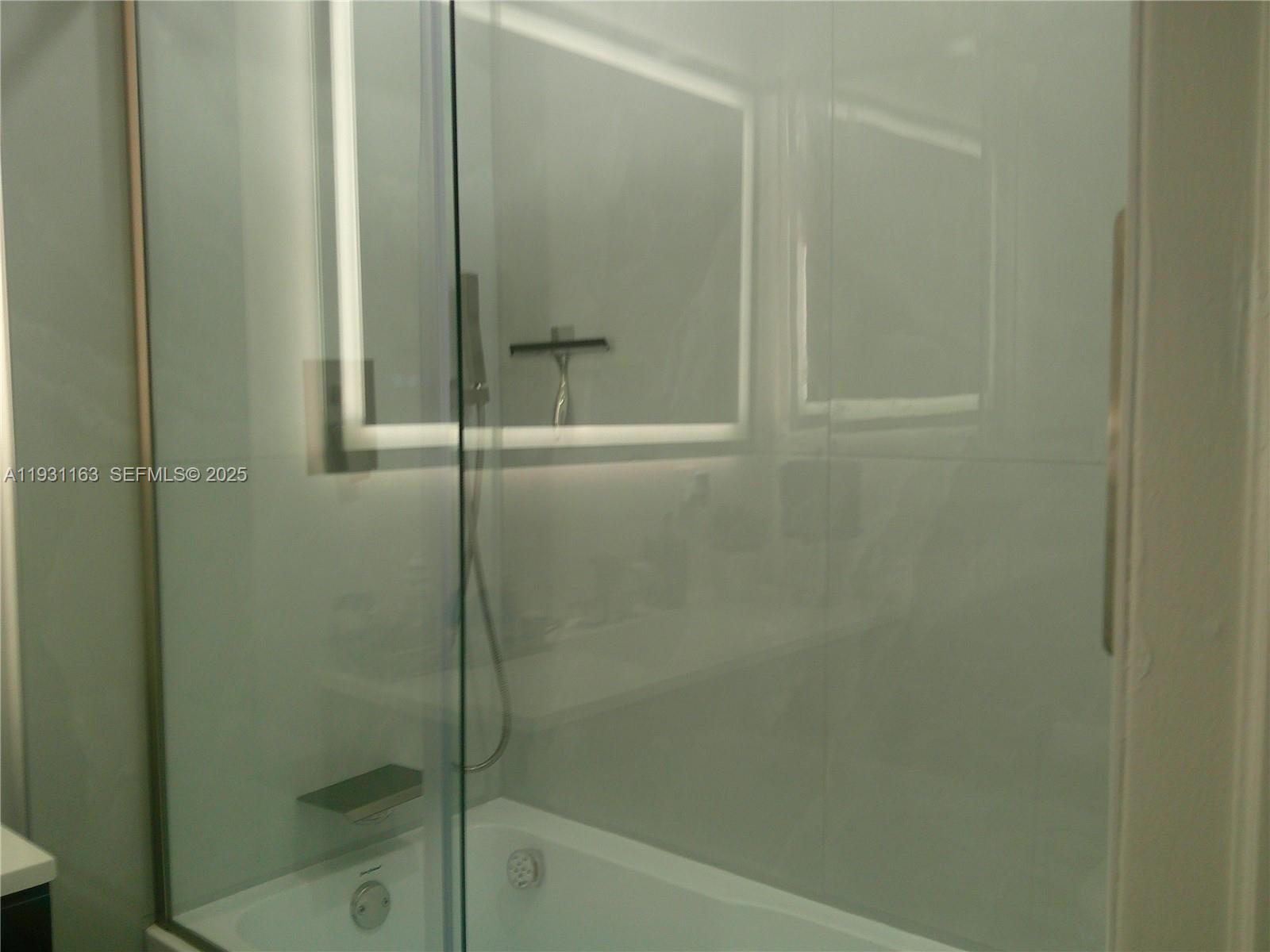 26831 Southwest 119th Court Homestead, FL 33032 - Photo 16 of 27 a bathroom with a glass shower door