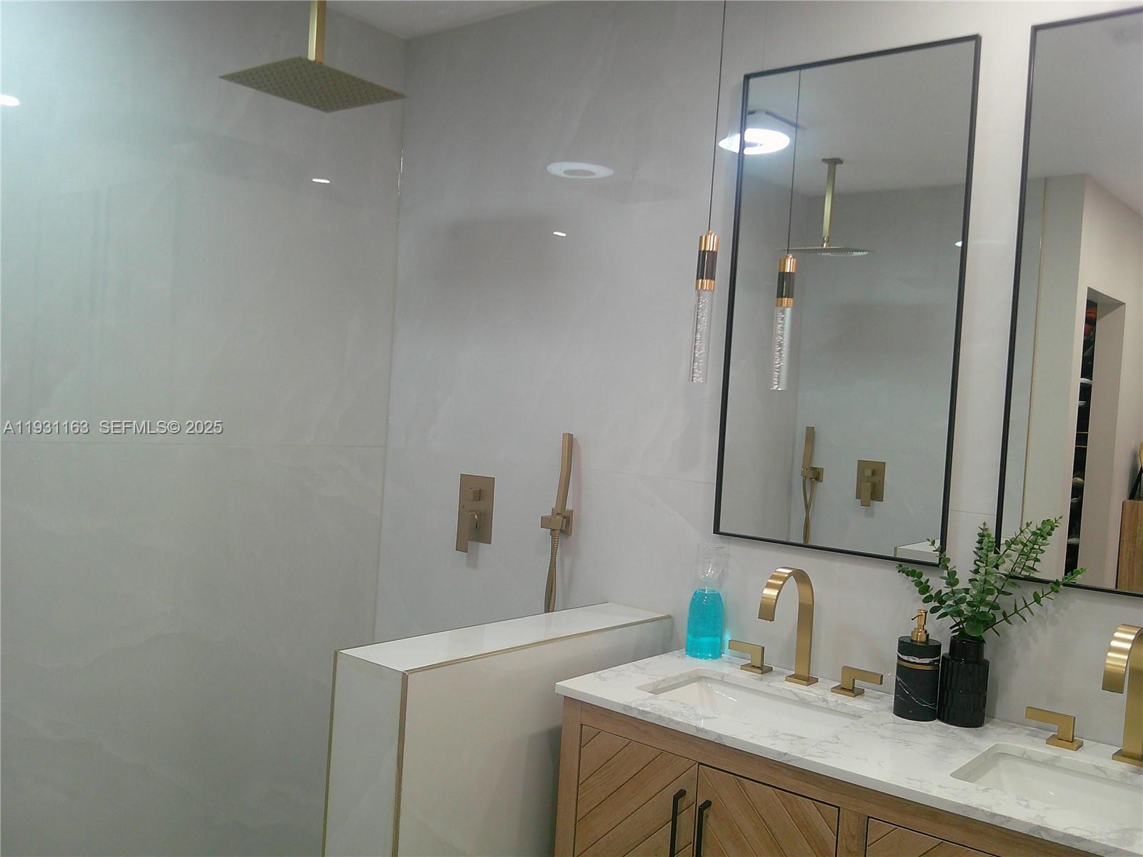 26831 Southwest 119th Court Homestead, FL 33032 - Photo 22 of 27 a bathroom with a sink and a mirror