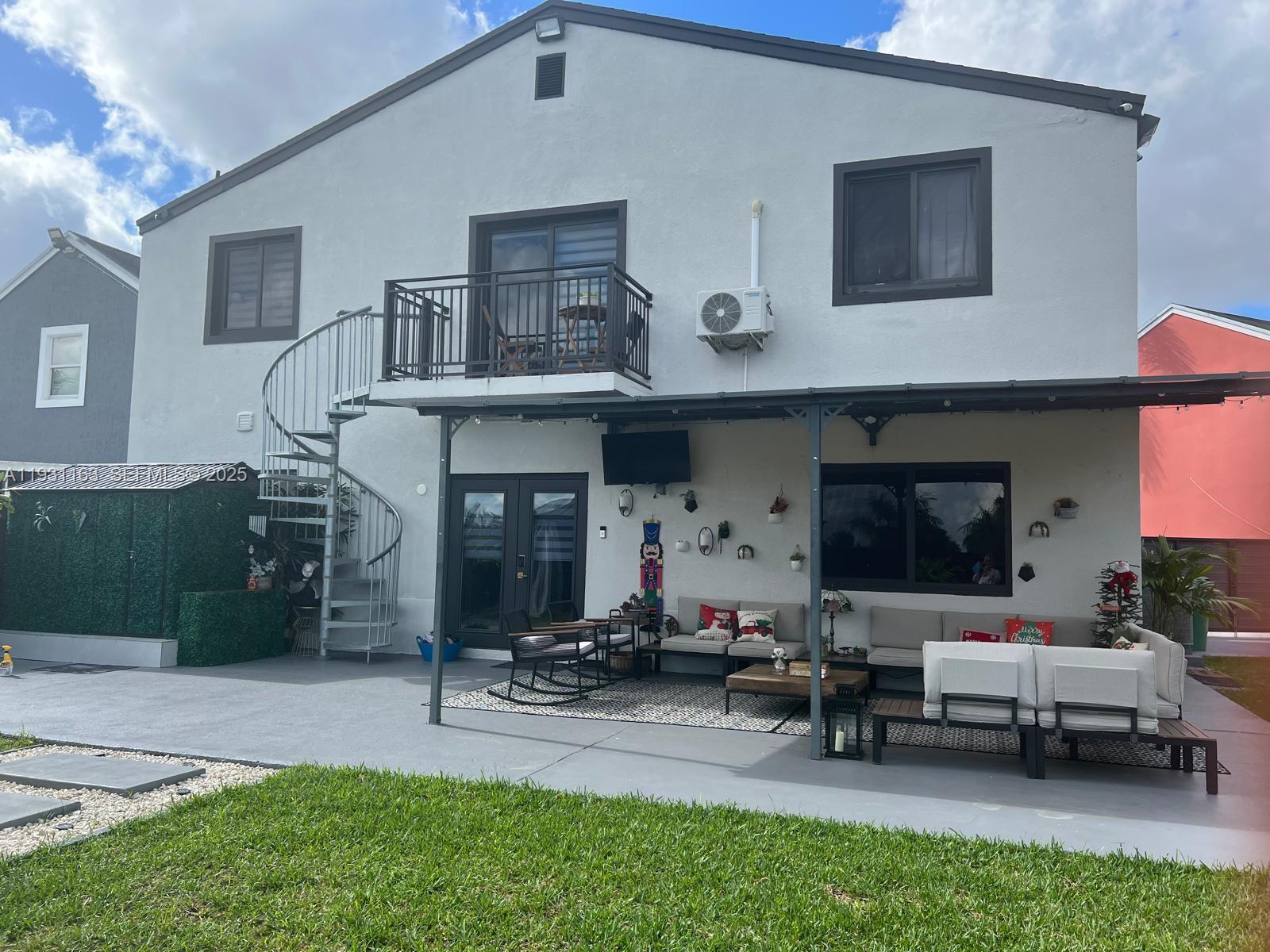 26831 Southwest 119th Court Homestead, FL 33032 - Photo 5 of 27 a living room with furniture a window and a fireplace