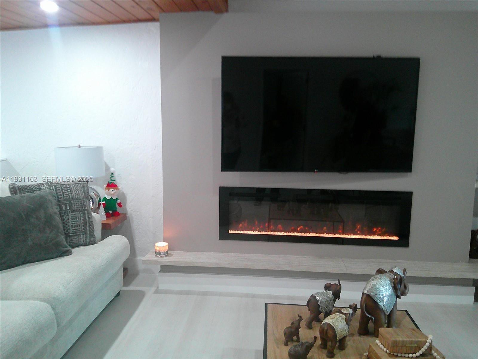 26831 Southwest 119th Court Homestead, FL 33032 - Photo 7 of 27 a living room with furniture and a fireplace