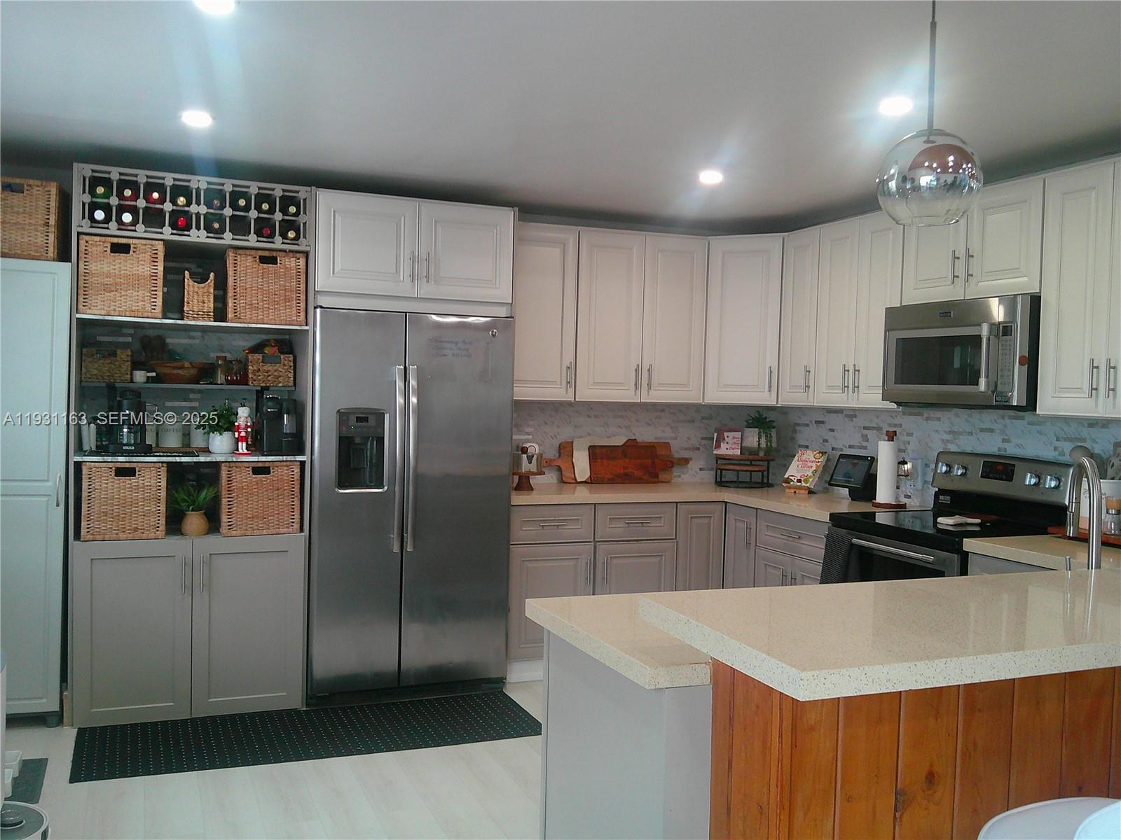 26831 Southwest 119th Court Homestead, FL 33032 - Photo 10 of 27 a kitchen with stainless steel appliances a refrigerator sink and microwave