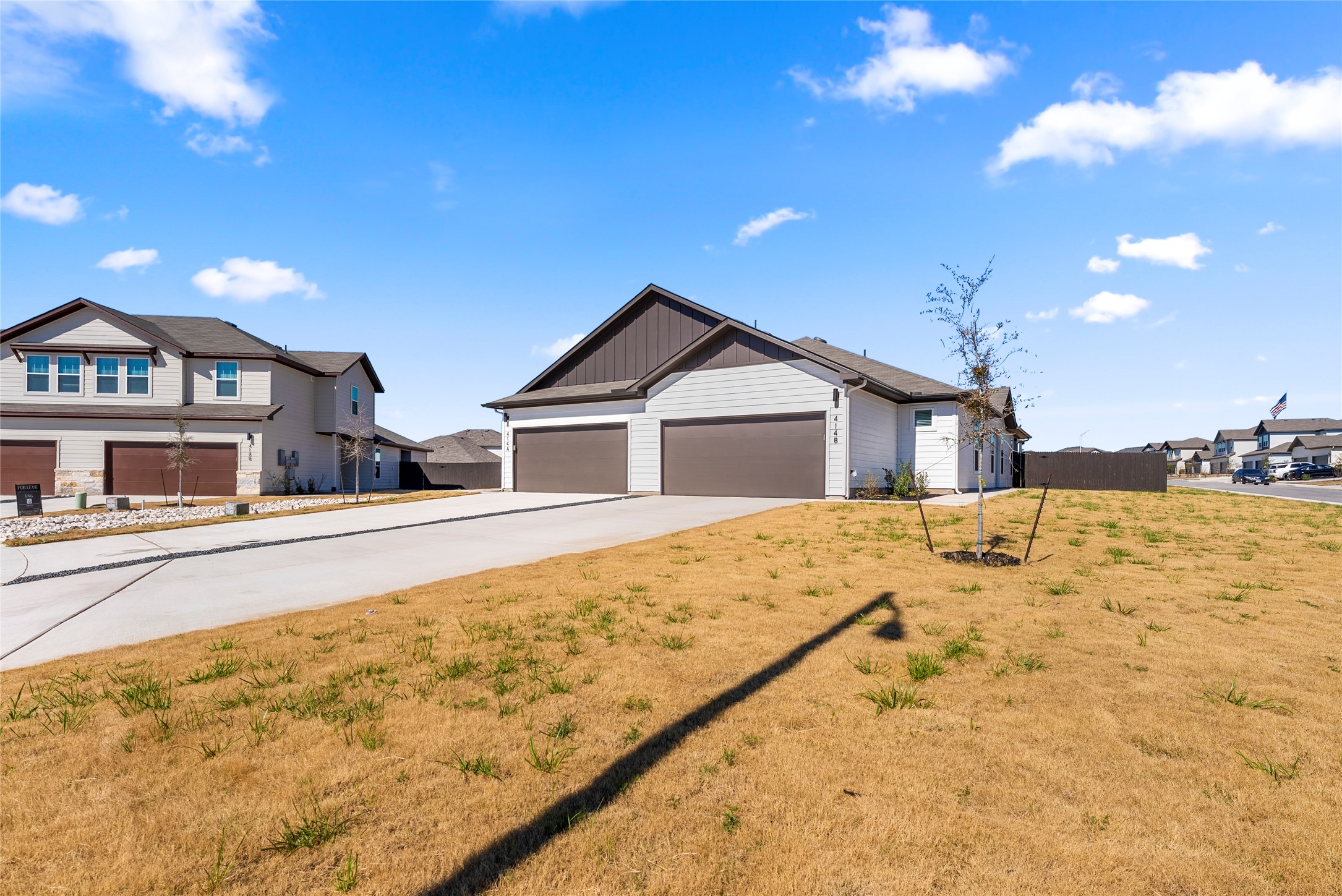 View of front of home featuring driveway, board and batten siding, and a garage