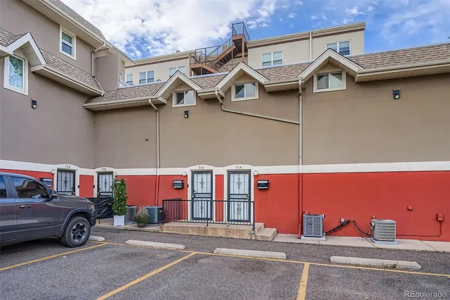 a view of a street that has couple of cars parked in front of it