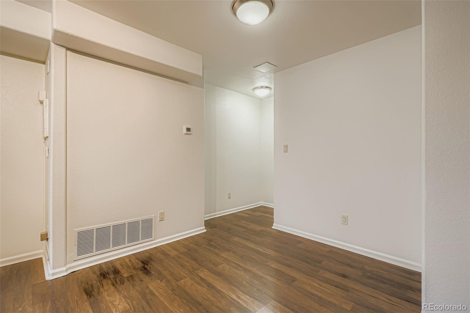 714 East 18th Avenue Denver, CO 80203 - Photo 9 of 20 a view of an empty room with wooden floor