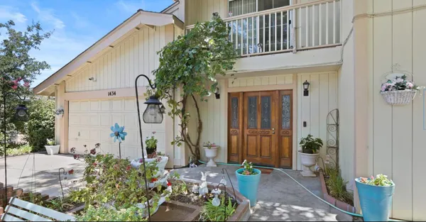 a front view of a house with a garden