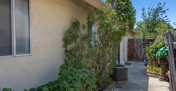 a view of house with backyard and garden