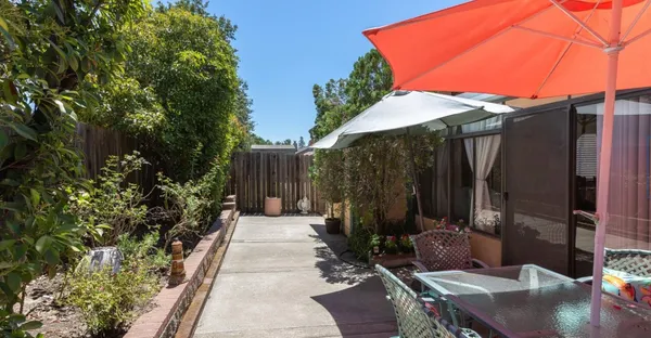 a backyard of a house with table and chairs