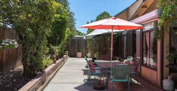an outdoor space with furniture and umbrella