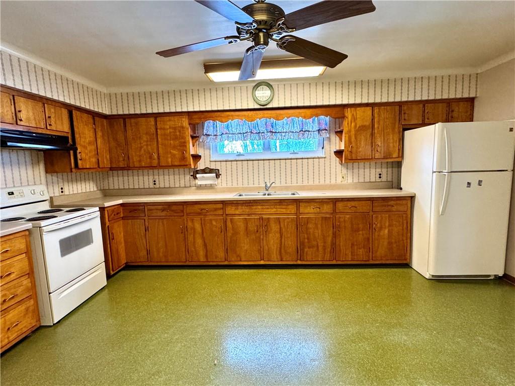 260 Simon Drive Butler, PA 16002 - Photo 11 of 46 a kitchen with stainless steel appliances a stove a sink cabinets and a counter top space