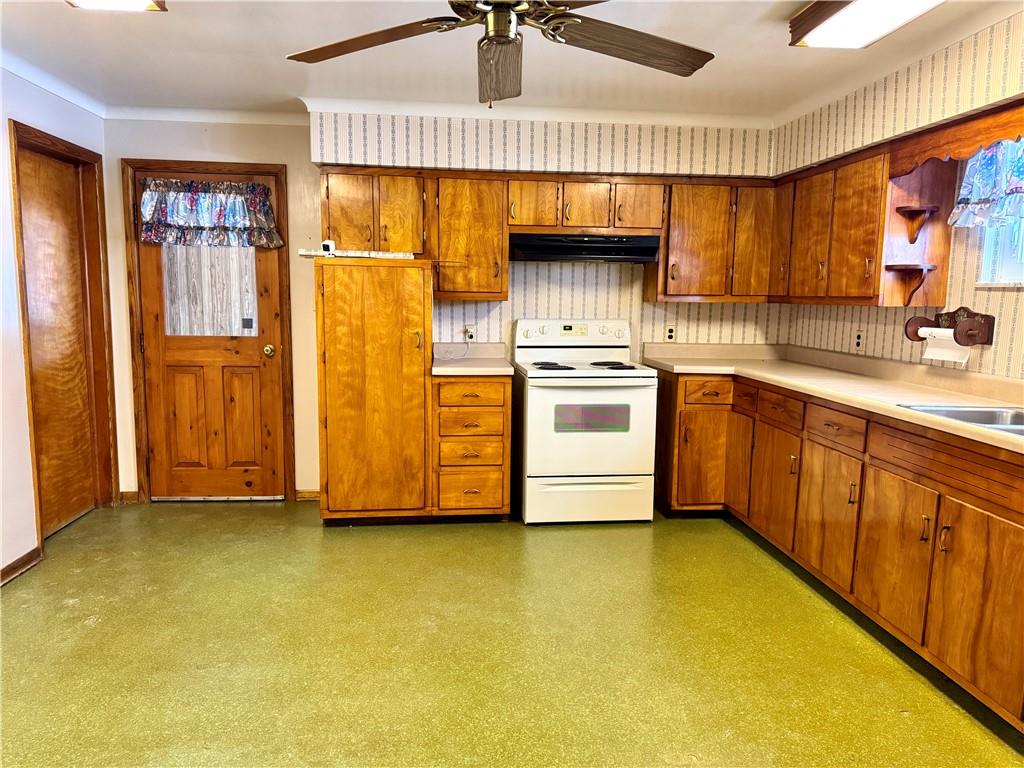 260 Simon Drive Butler, PA 16002 - Photo 12 of 46 a kitchen with a sink a stove cabinets and a window