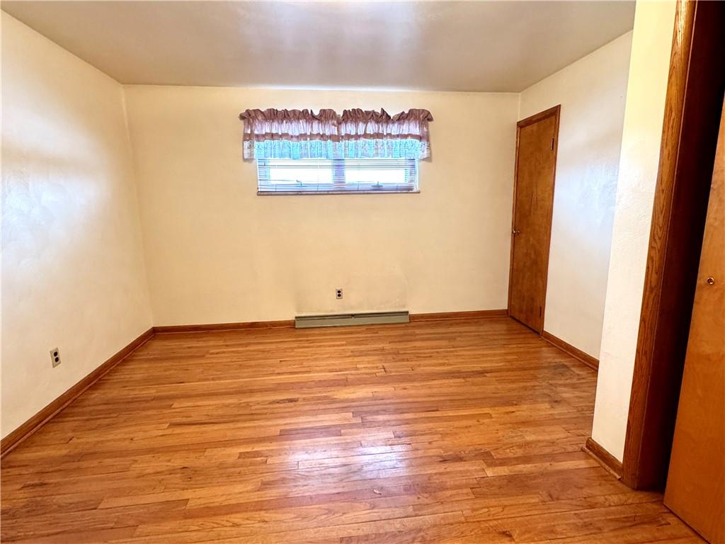 260 Simon Drive Butler, PA 16002 - Photo 22 of 46 a view of an empty room with wooden floor and a window