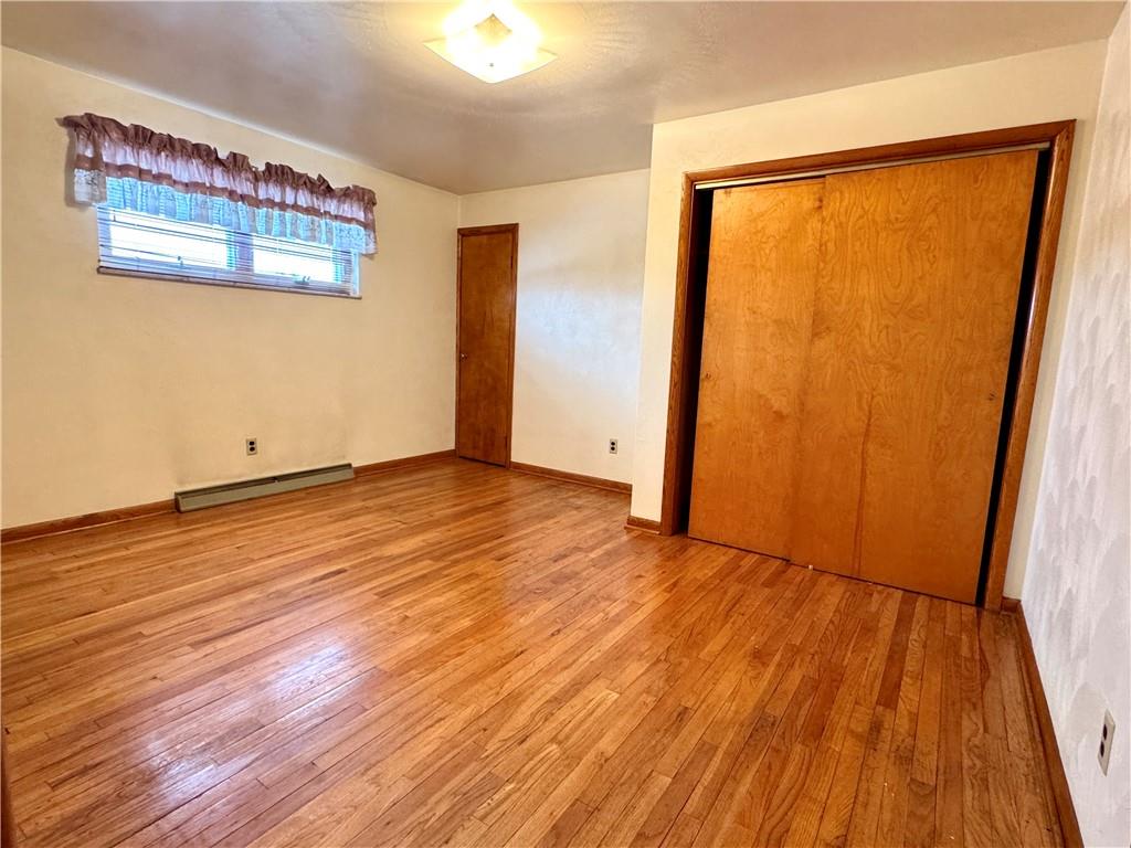 260 Simon Drive Butler, PA 16002 - Photo 23 of 46 a view of an empty room with wooden floor and a window