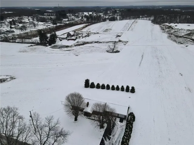 a view of a terrace with a bench and trees around