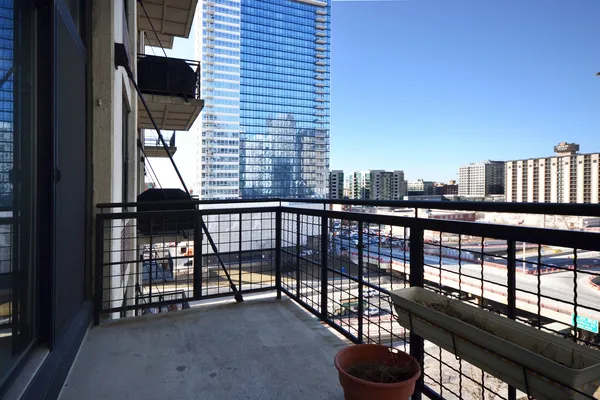 a view of balcony with a potted plant and a table